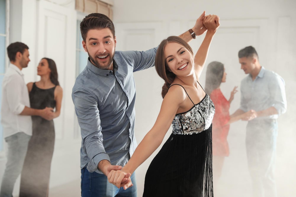 Lovely young couple dancing together at party